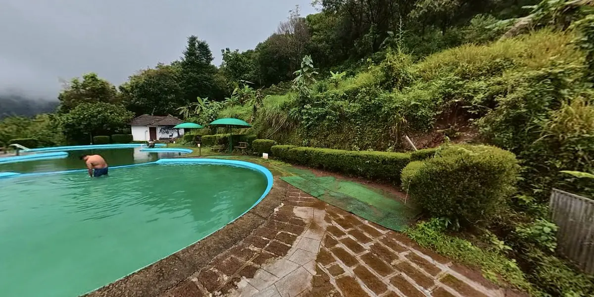 360° view of the pool terrace, with the main block on the hill above